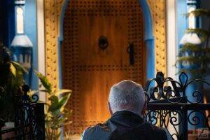 A tourist takes a photo of a moroccan door